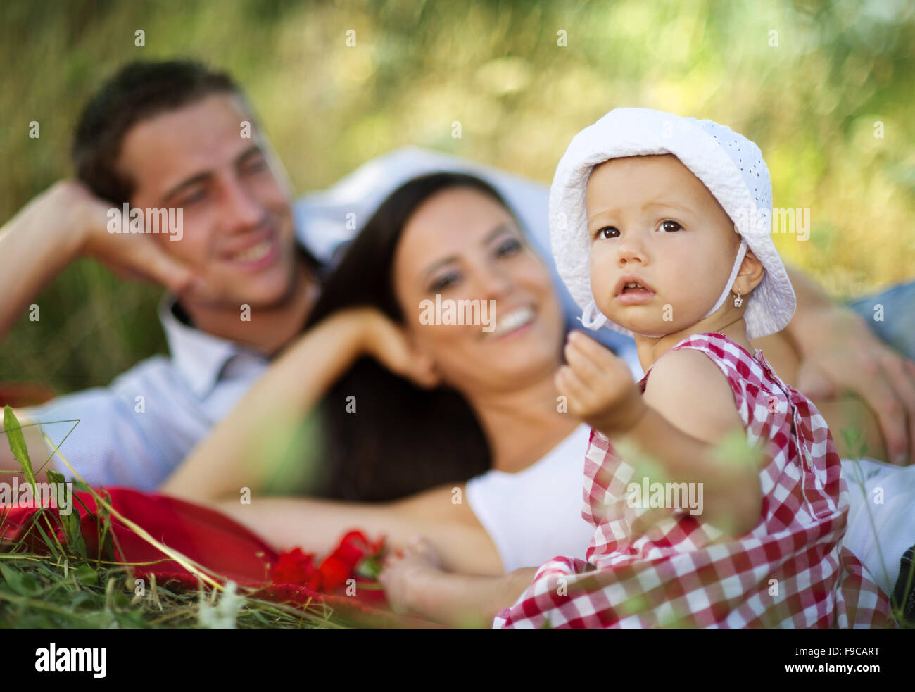 Happy young family spending time outdoor on a summer day Stock Photo