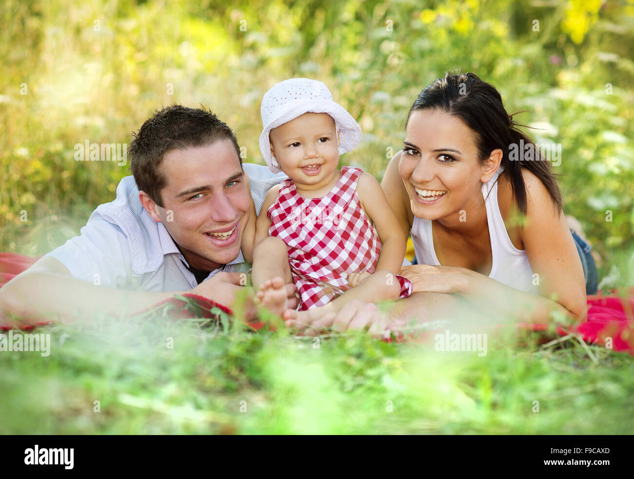 Happy young family spending time outdoor on a summer day Stock Photo