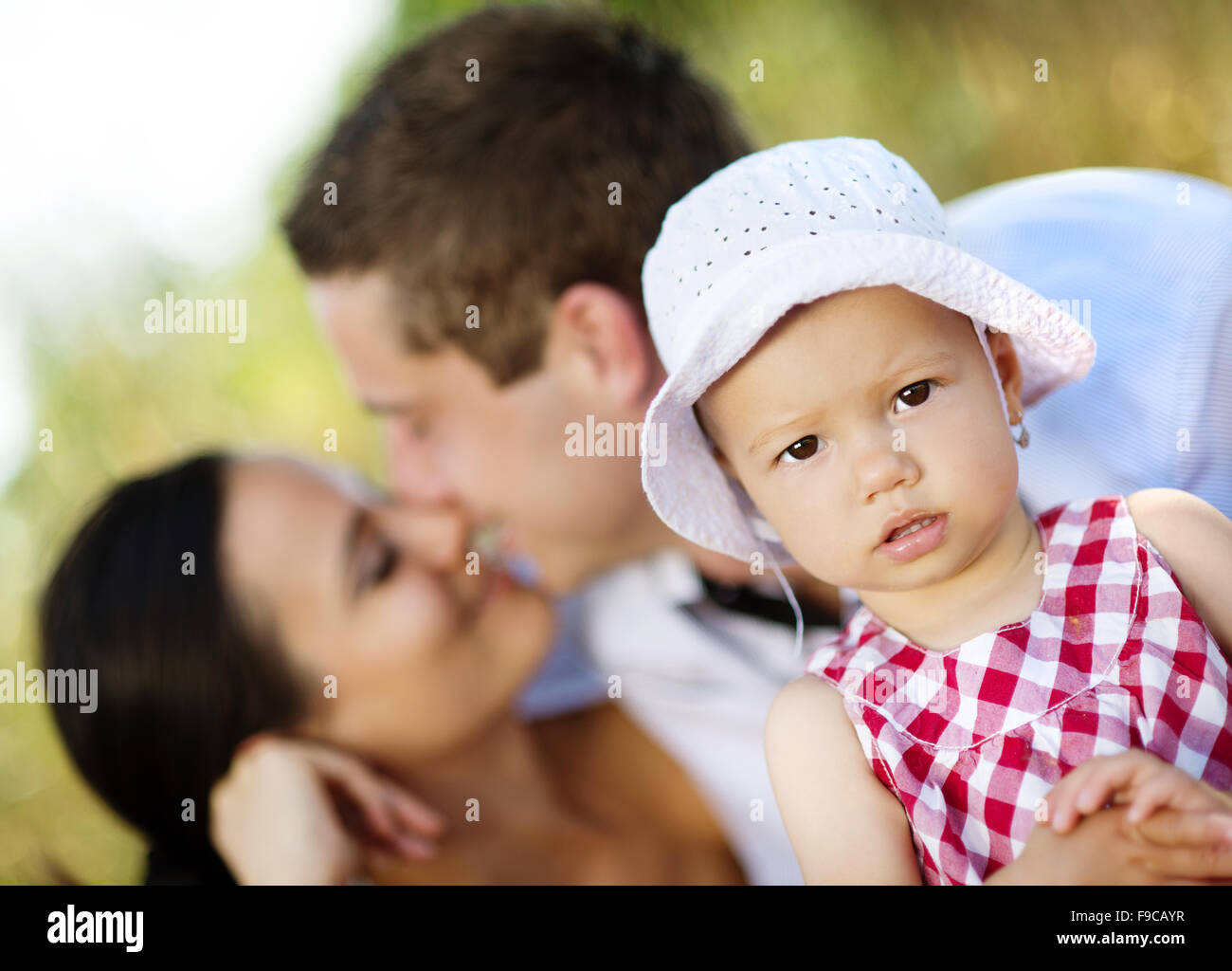 Happy young family spending time outdoor on a summer day Stock Photo