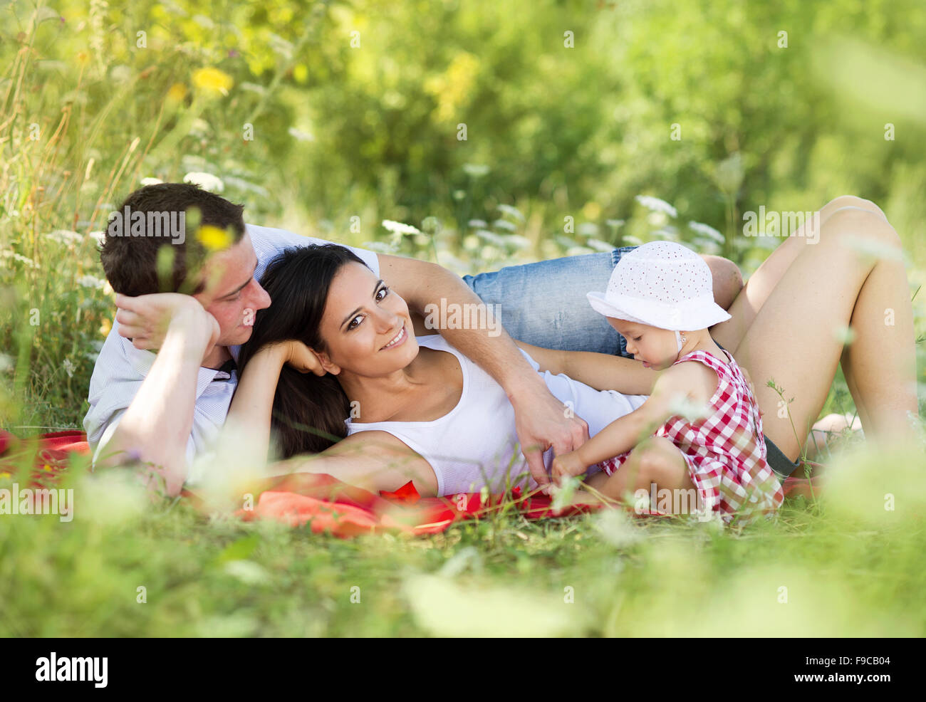 Happy young family spending time outdoor on a summer day Stock Photo