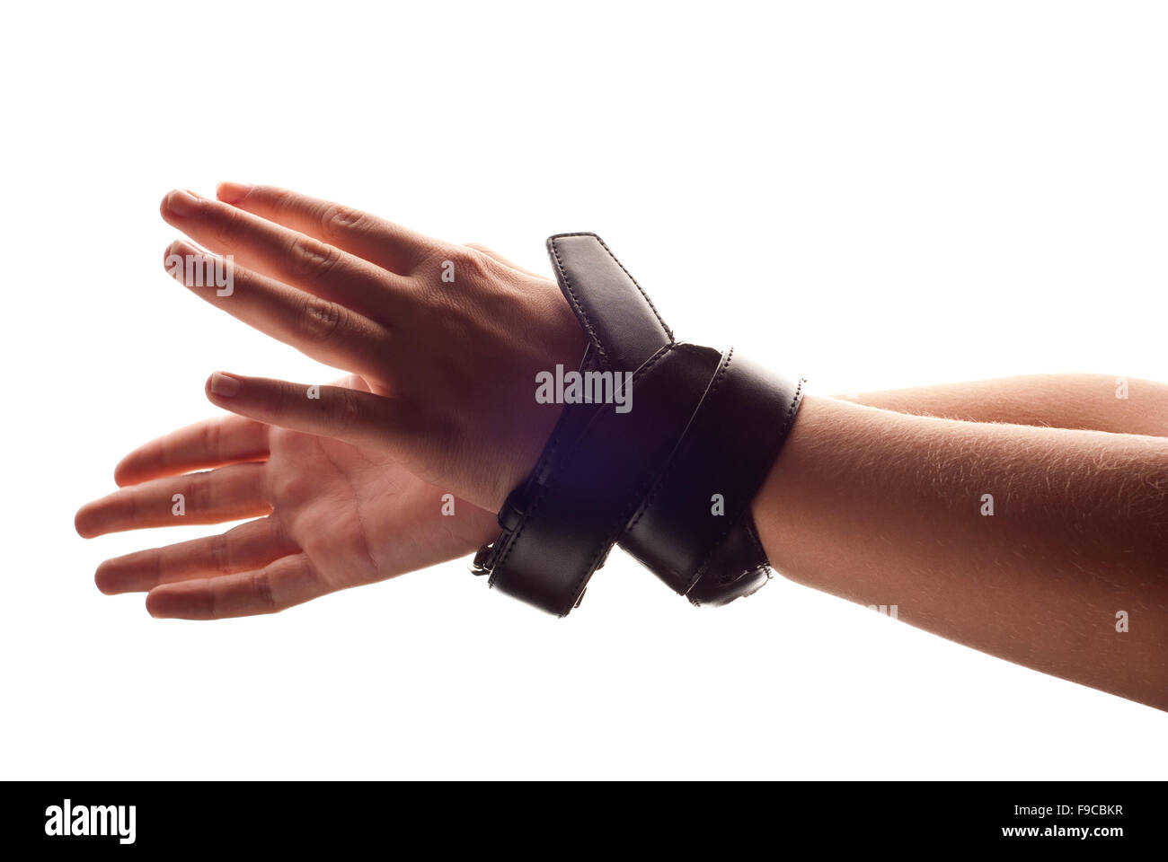 Hands of child are tied up by belt Stock Photo - Alamy