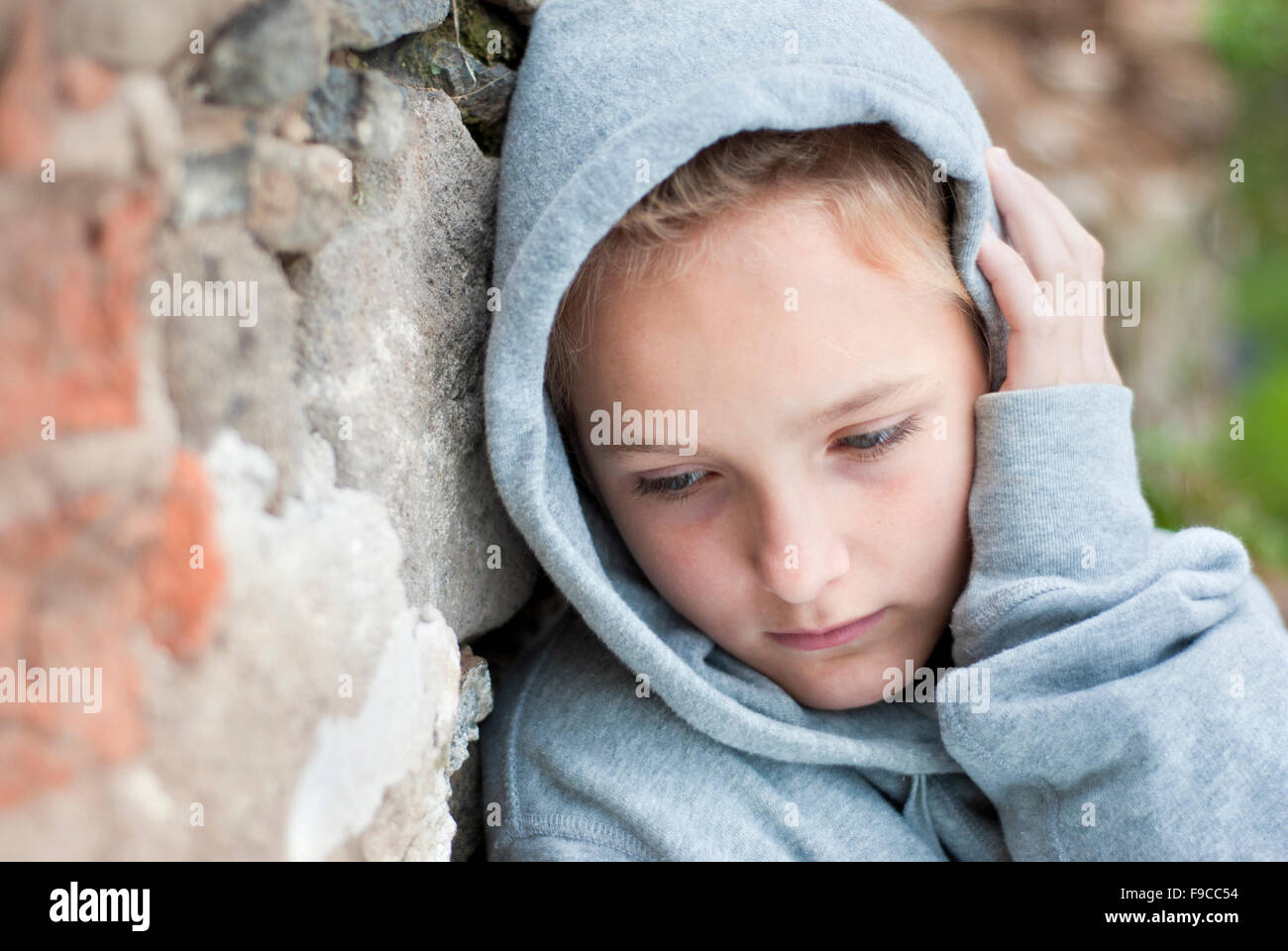 Little sad child with hoody. Stock Photo