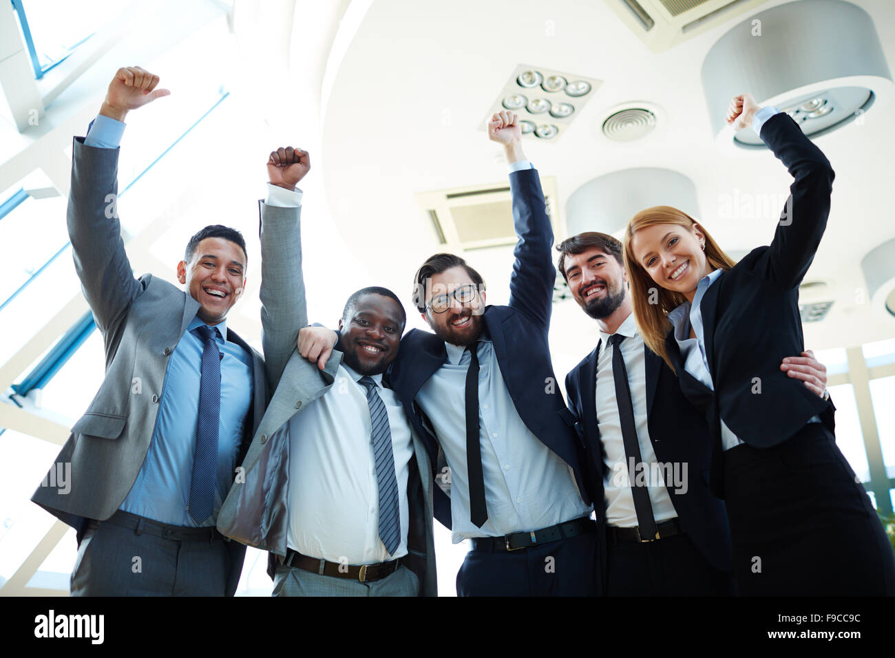 Business team raise hi-res stock photography and images - Alamy