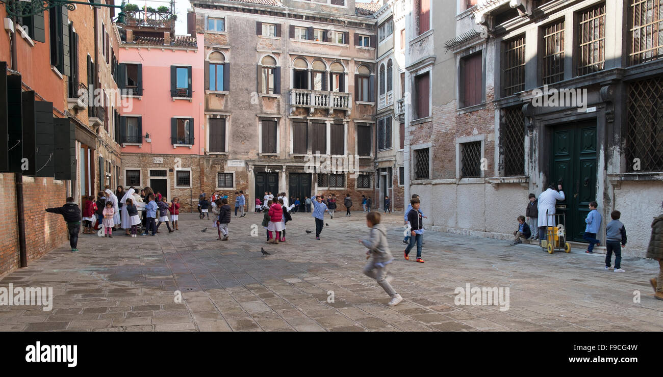 Kids playing in a little square in Venice Stock Photo