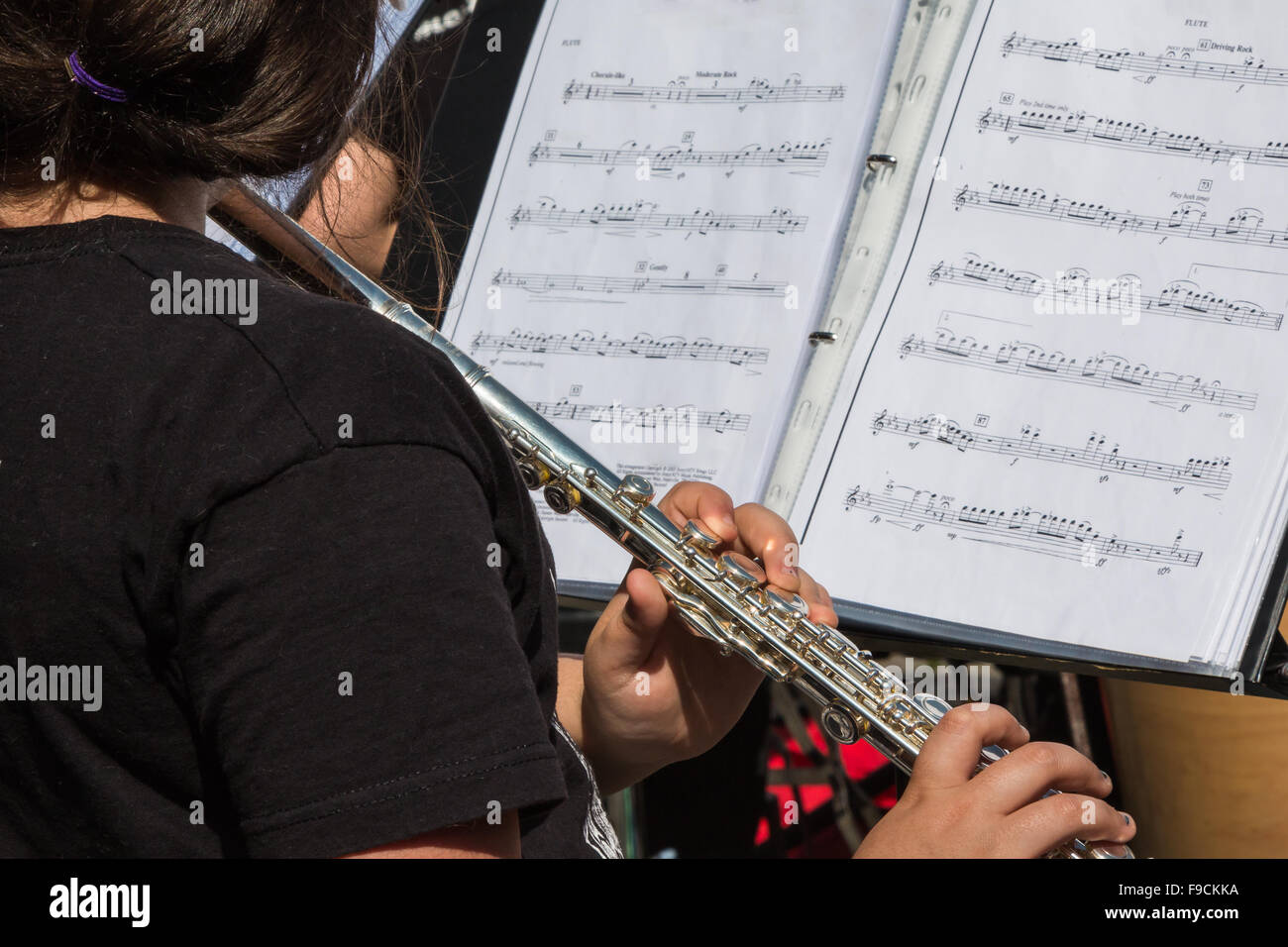 Playing Transverse Flute Instrument during Outdoor Concert, Score on