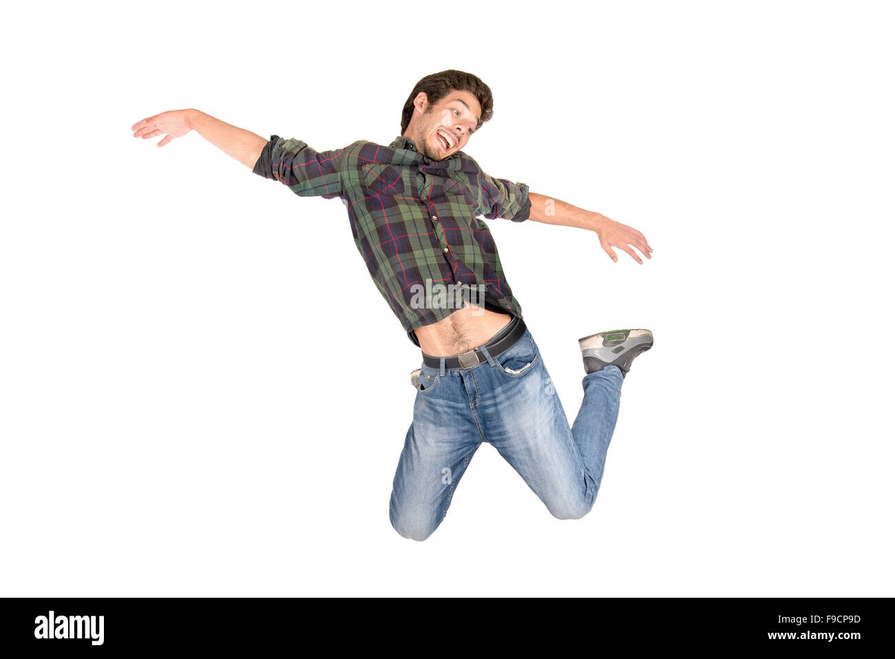 Teenage boy  doing funny acrobatic jumps isolated in white Stock Photo