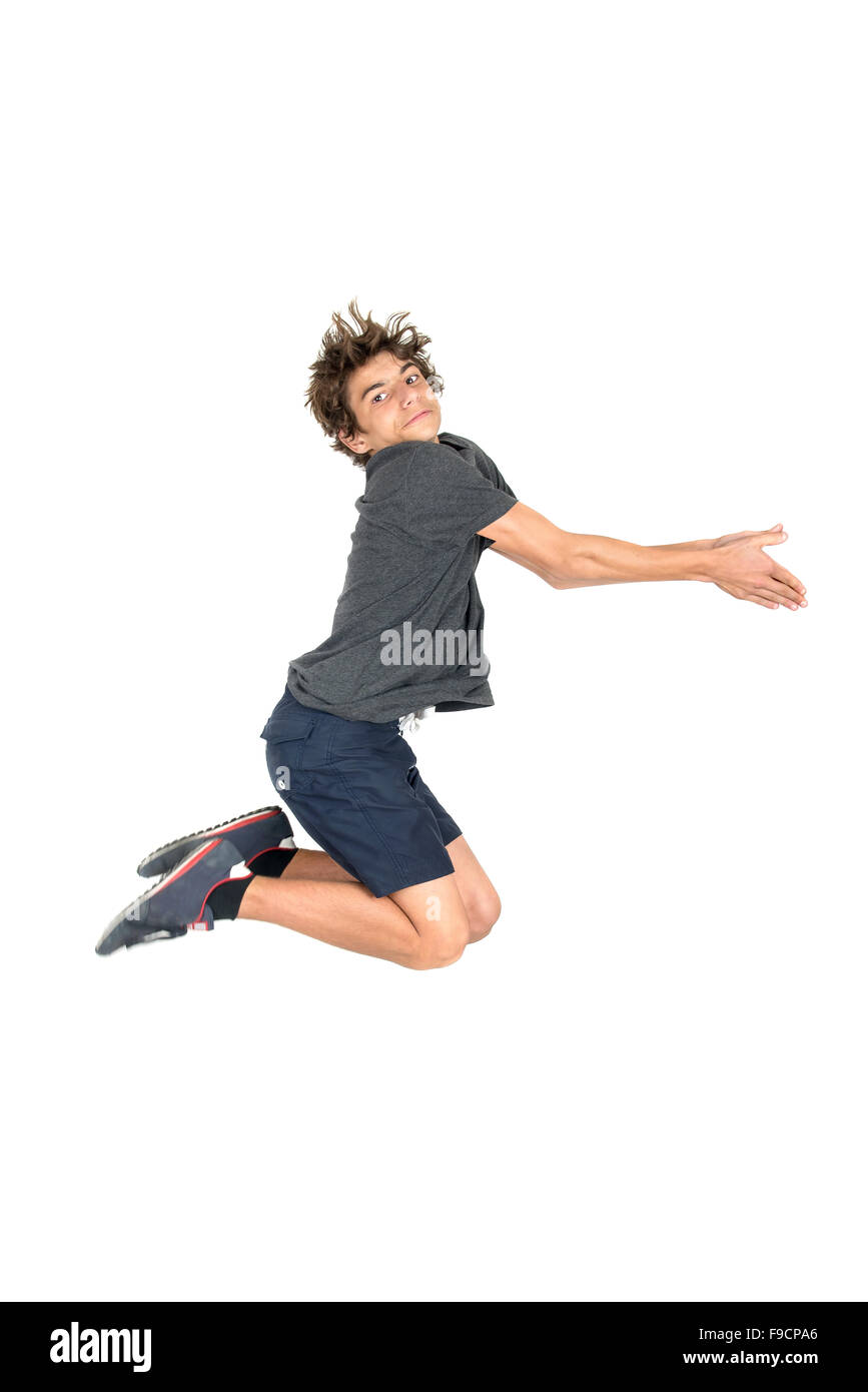 Teenage boy doing funny acrobatic jumps isolated in white Stock Photo