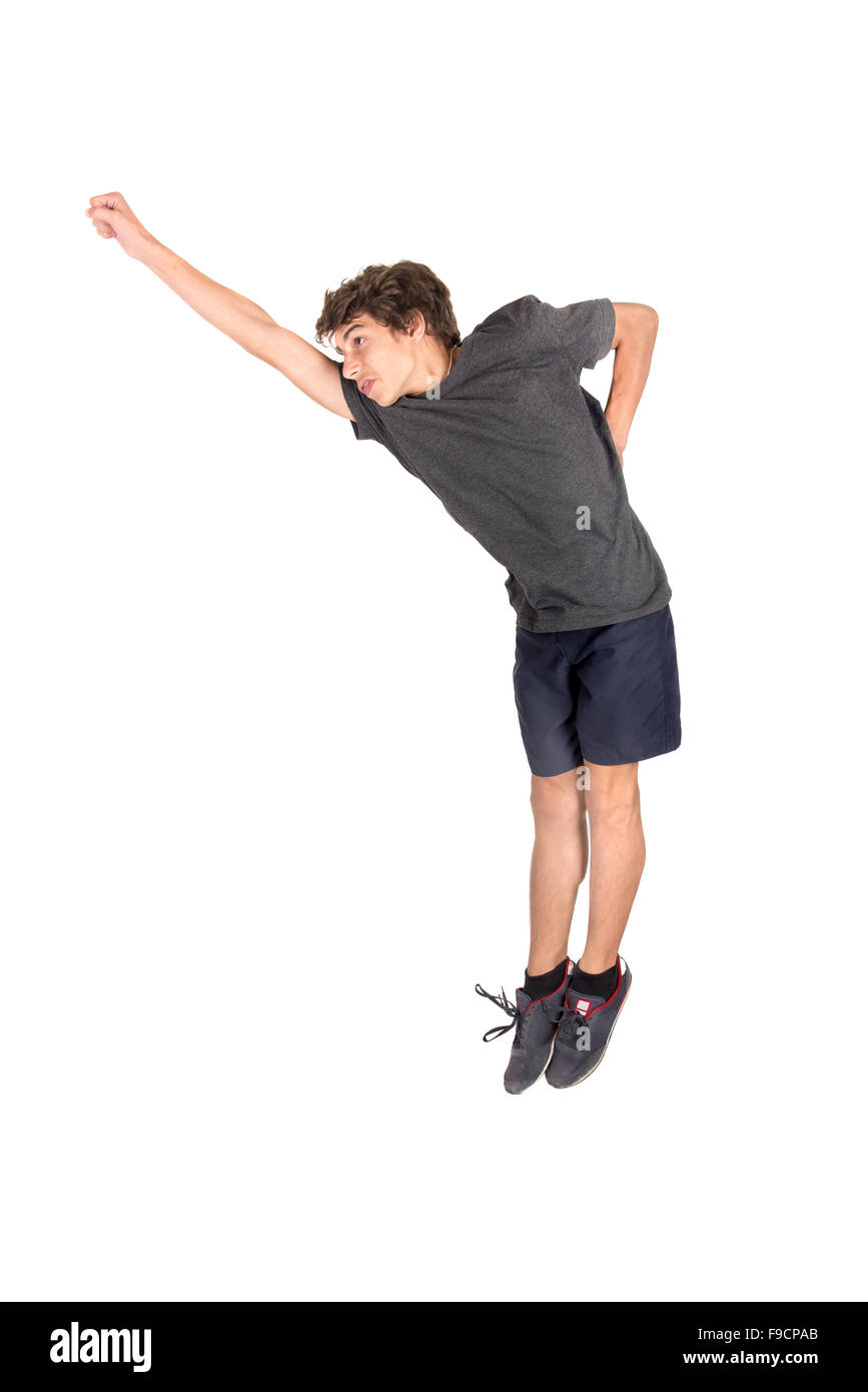 Teenage boy doing funny acrobatic jumps isolated in white Stock Photo