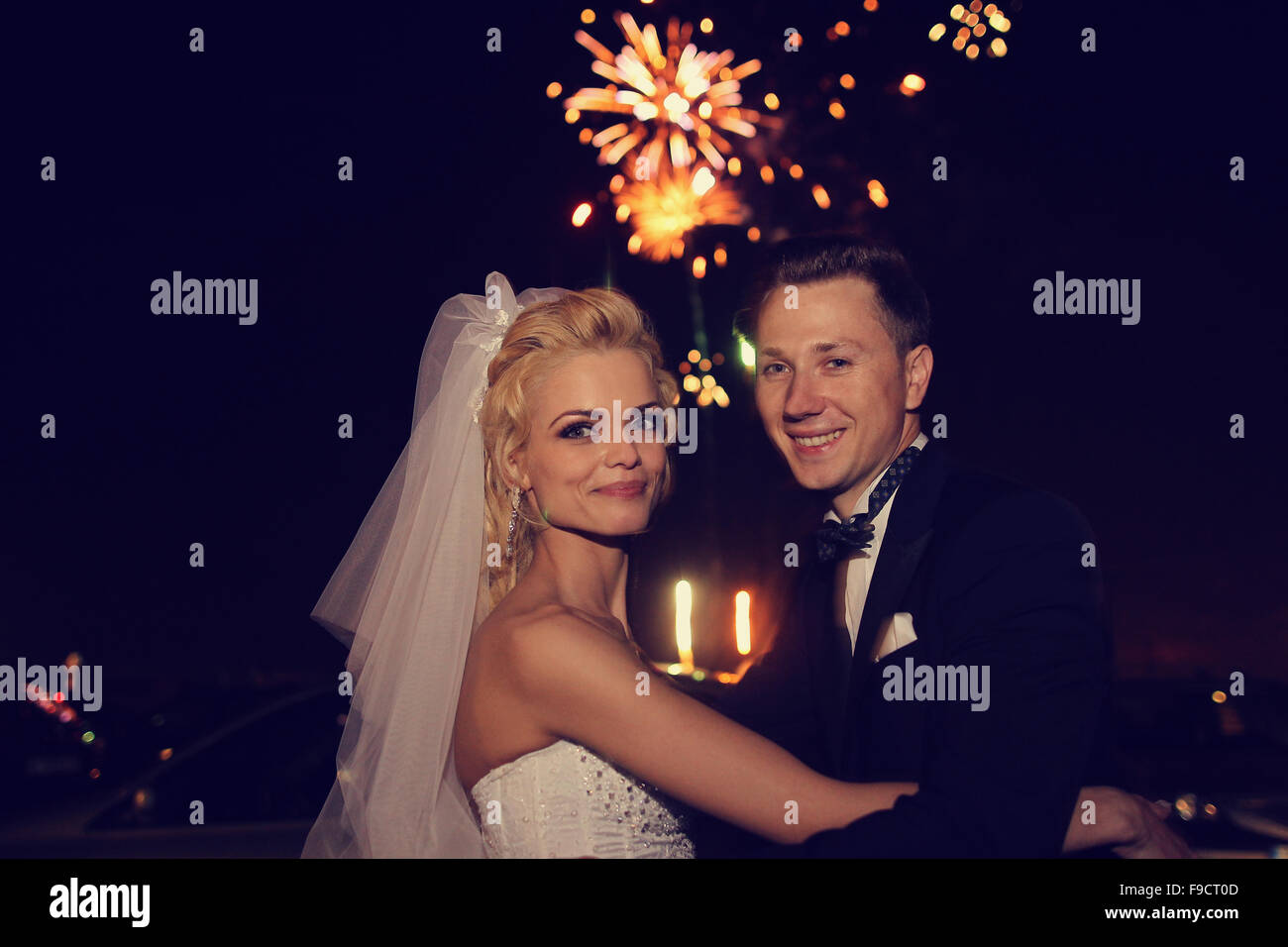 Beautiful bridal couple dancing sorrounded by fireworks Stock Photo