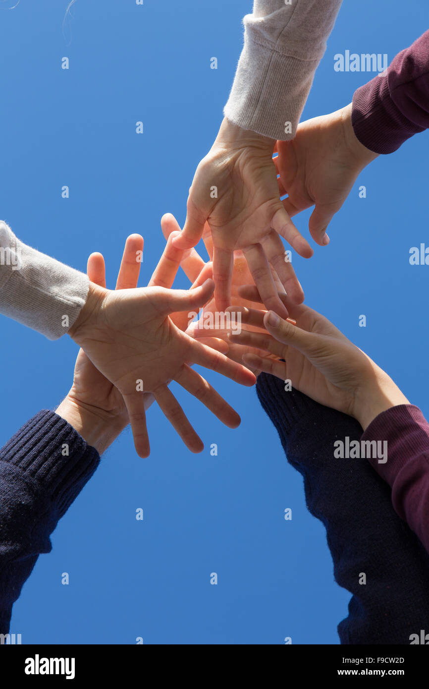 A family holding hands against a blue sky Stock Photo - Alamy