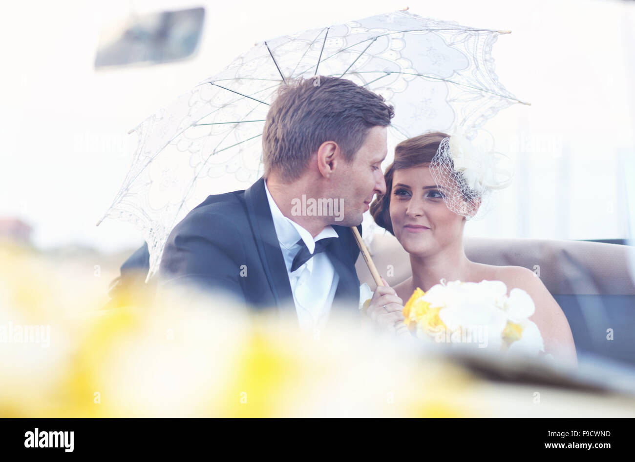 Bride and groom in a vintage car Stock Photo - Alamy