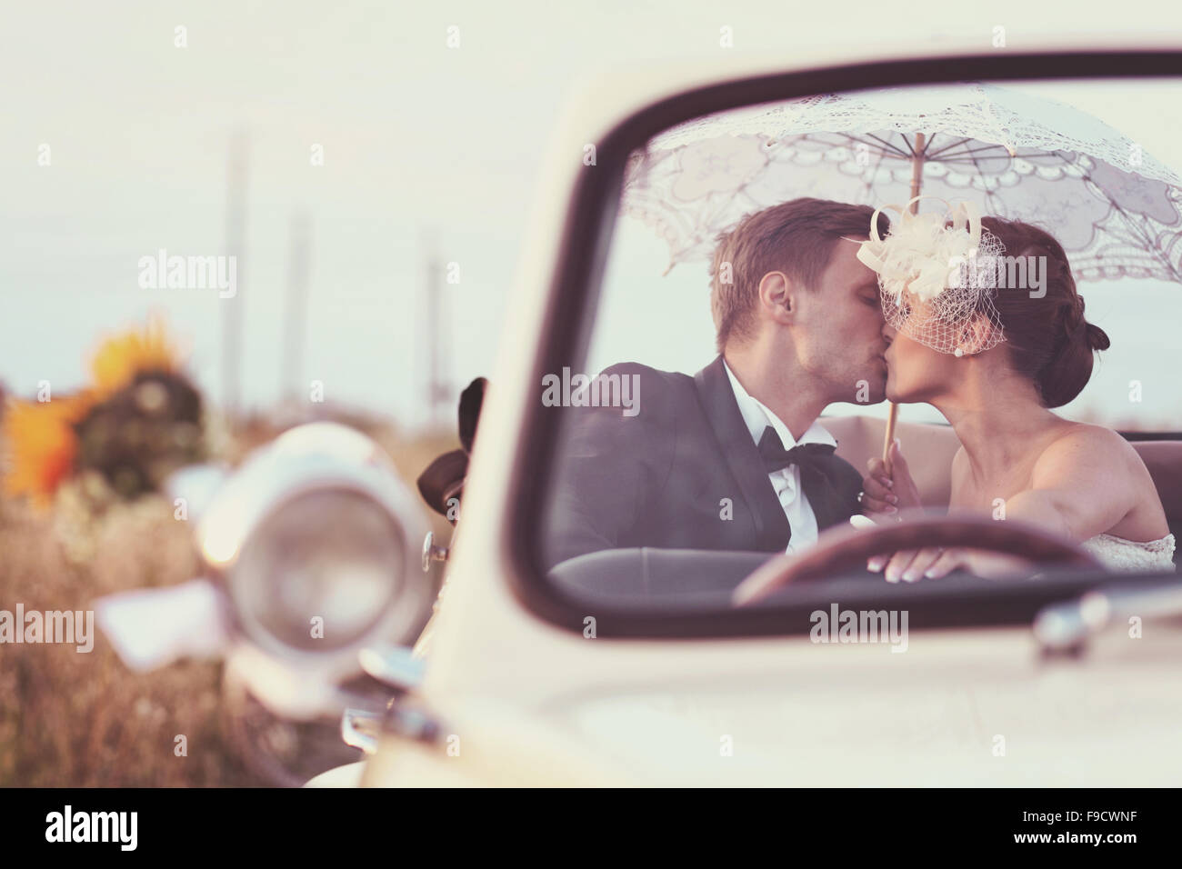 Bride and groom in a vintage car Stock Photo - Alamy