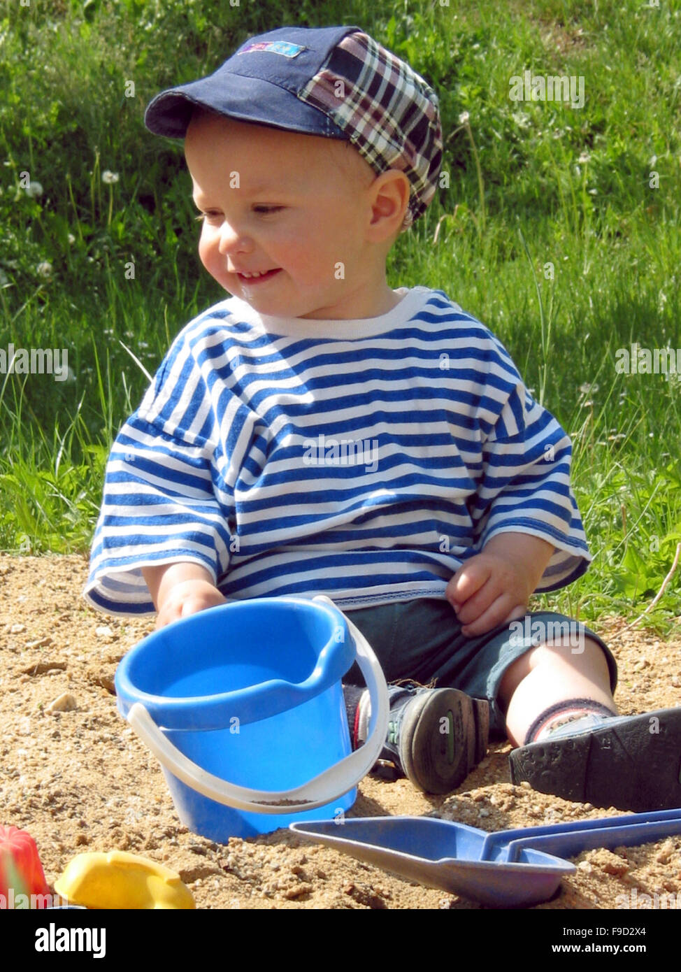 Little boy playing outdoors Stock Photo - Alamy