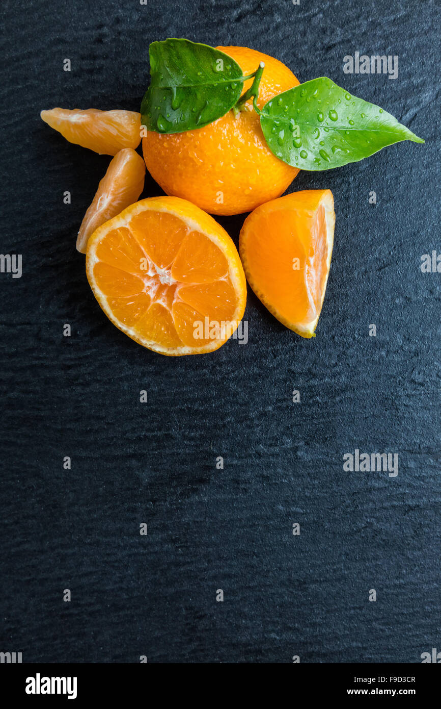 Fresh mandarin on black stone Stock Photo