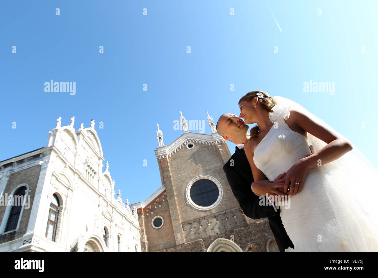 Wedding day of young pair isolated on blue sky Stock Photo - Alamy