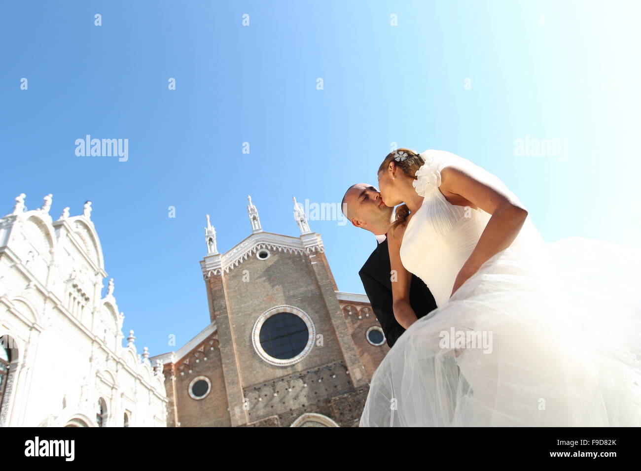 Wedding day of young pair isolated on blue sky Stock Photo - Alamy