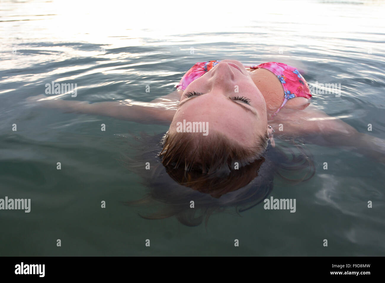 Woman Laying in Water Stock Photo - Alamy