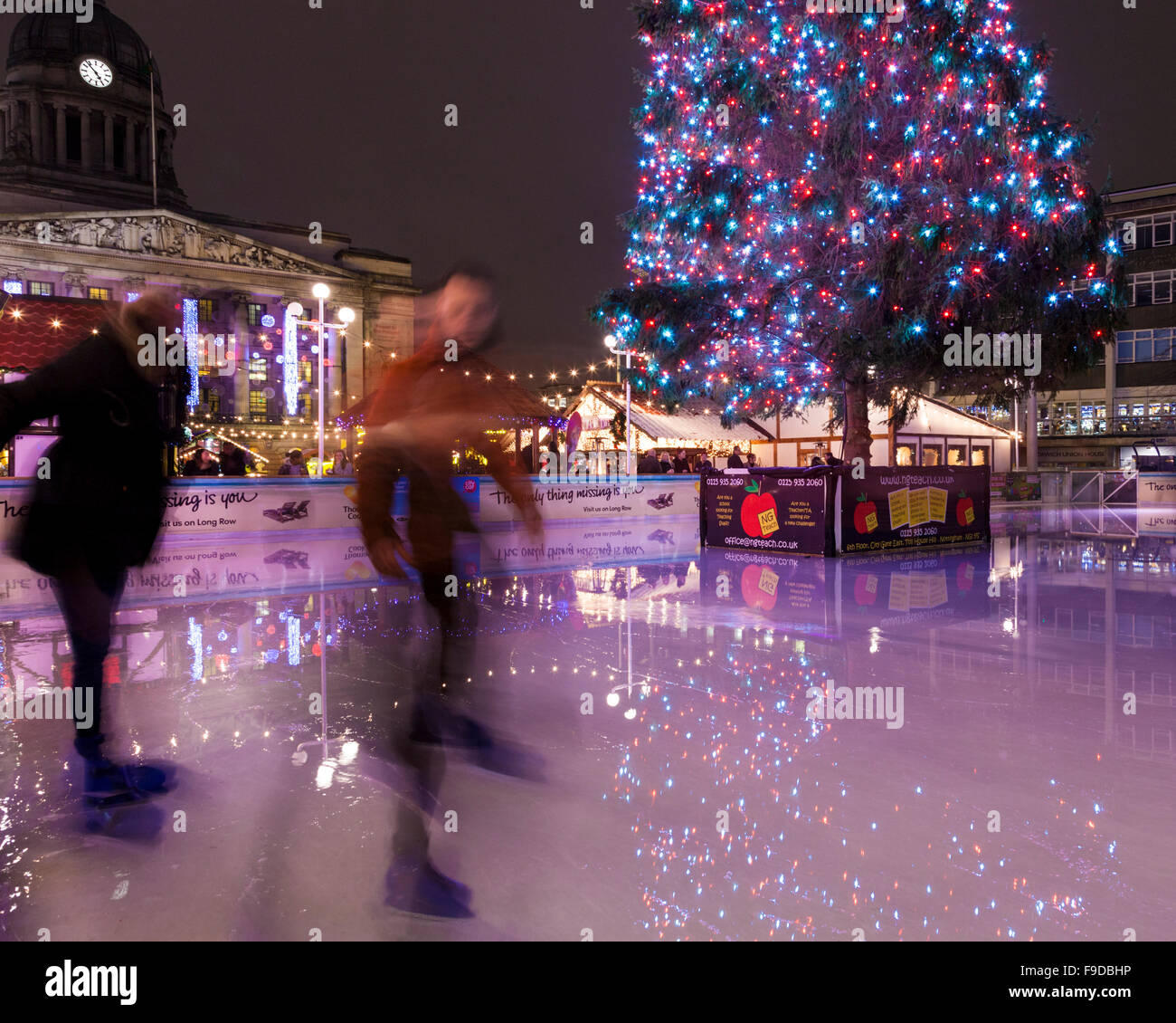 People skating on the ice rink at Christmas in the Old Market Square, Nottingham, England, UK Stock Photo