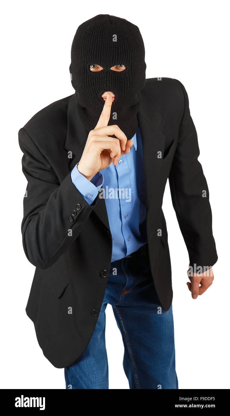 Thief in black mask in suit with finger signaling to be quite isolated on white background Stock Photo