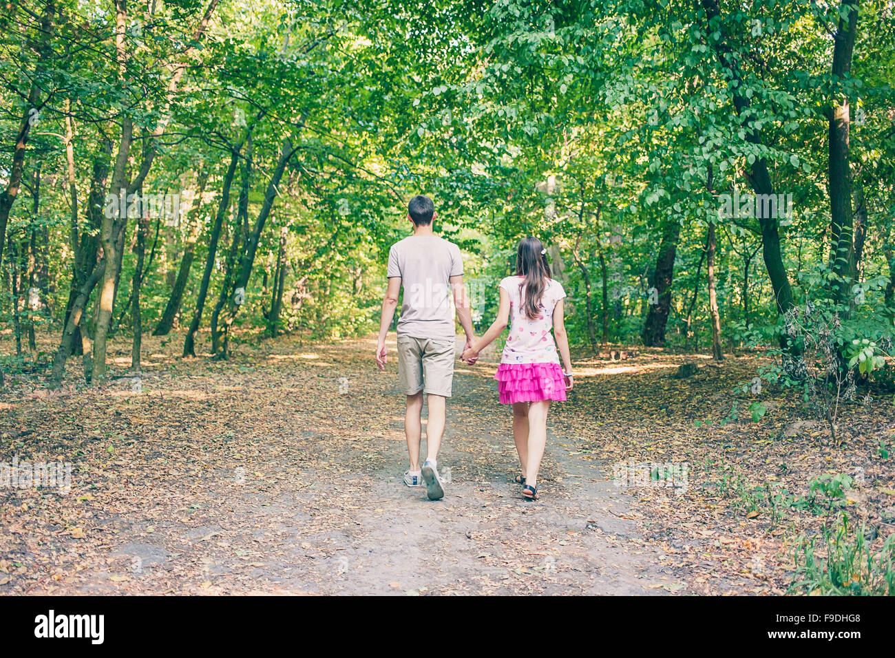 Couple walking in the park in summer. View from the back Stock Photo ...