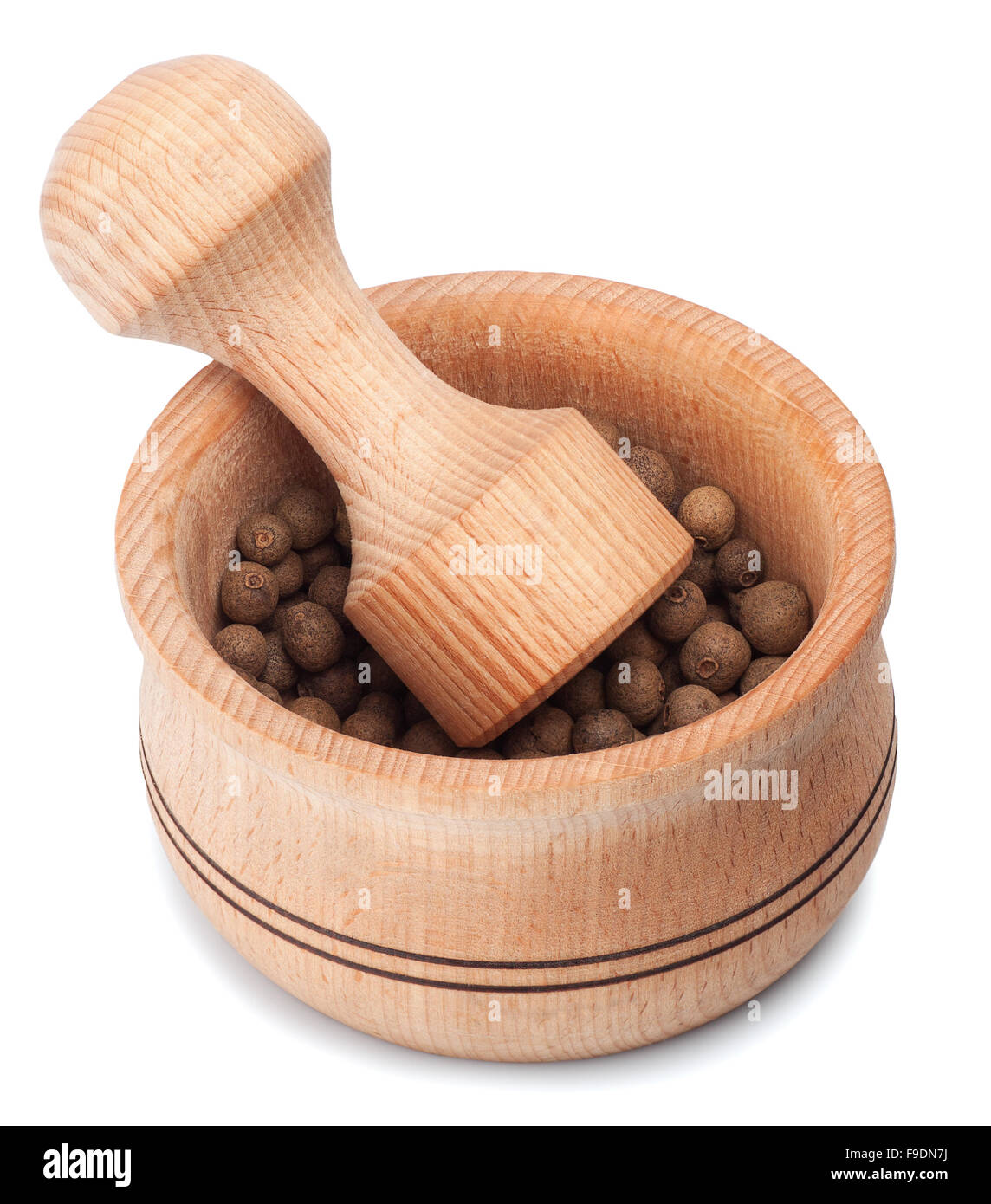 Wooden mortar and pestle with allspice isolated on white  background Stock Photo