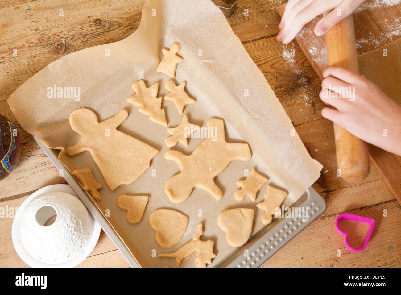 The making of gingerbread is a time honored tradition at Christmas. The gingerbread is cut from the dough and placed on a tray, Stock Photo