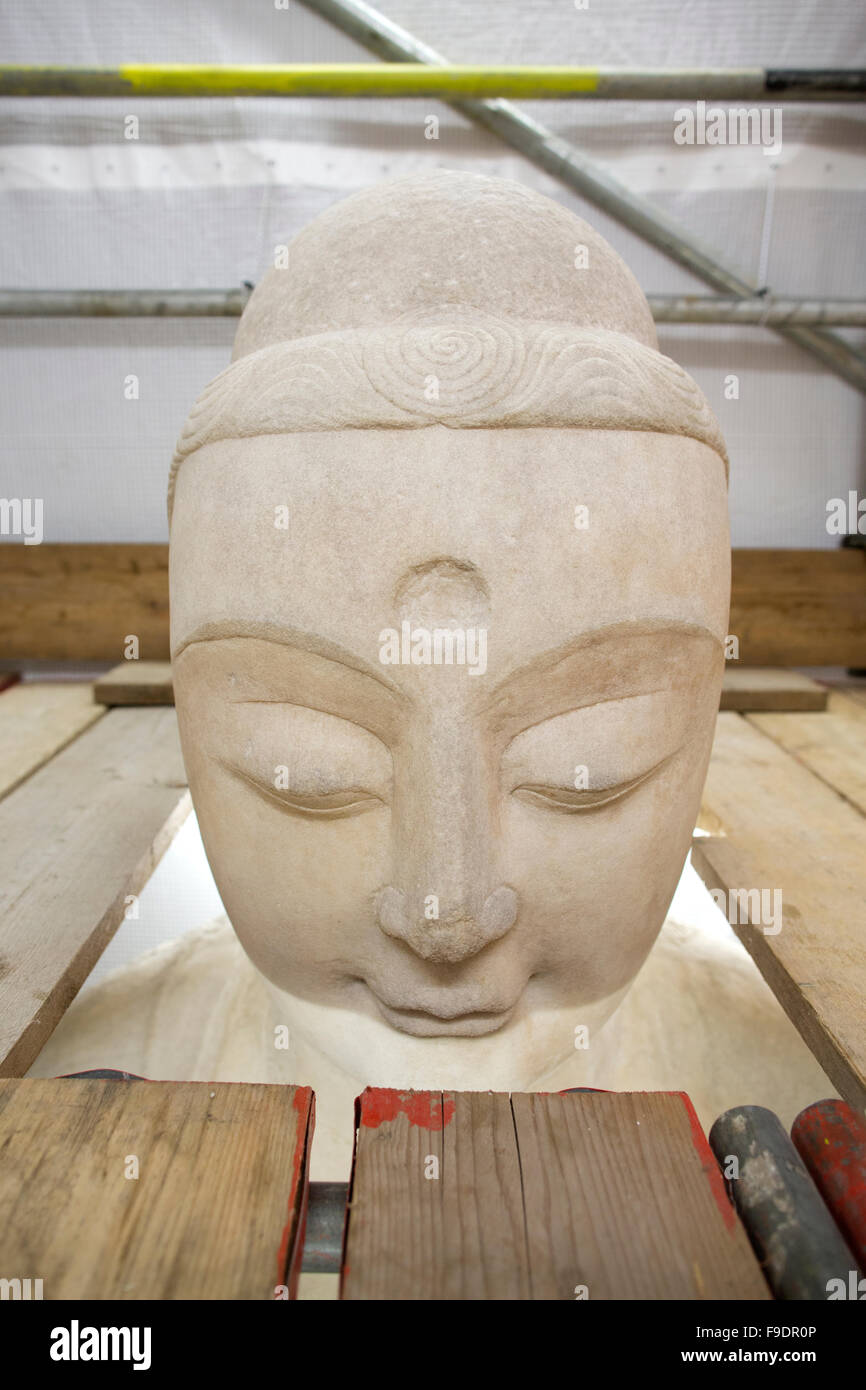 The white 19-foot-tall marble figure of Amitabha Buddha on the North Staircase being restored at the British Museum, London, UK Stock Photo
