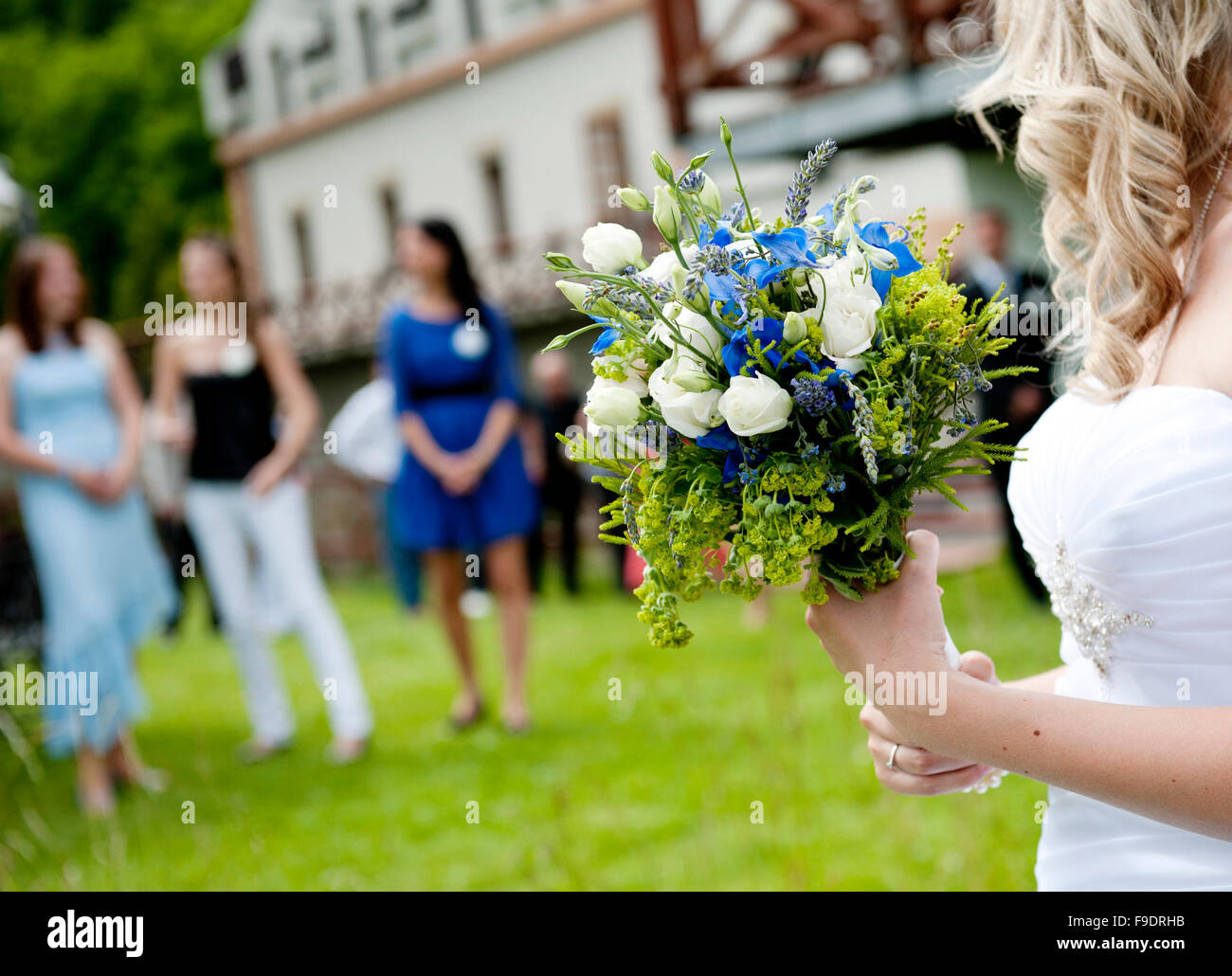Bride is ready to throw away her wedding bouquet Stock Photo