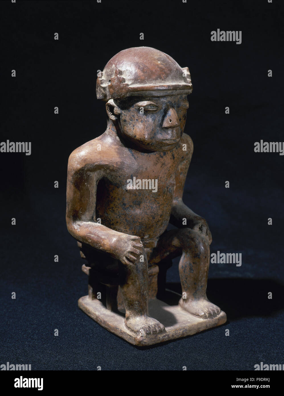 Pre-Columbian art. Pre-Incan. Negative Carchi culture. 850-1500 AD. 'Coquero'. Man sitting with hands on knees and chewing coca leaves.20 x 10,5 x 8 cm. From Ecuador. Private collection. Stock Photo