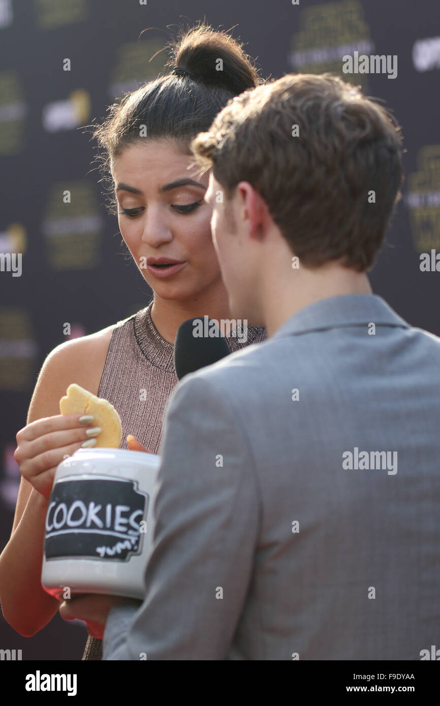Sydney, Australia. 16 December 2015. Singer Mia Morrissey tries cookies as  she arrives on the red carpet for the Sydney Premiere of Star Wars: The  Force Awakens at Hoyts Entertainment Quarter. Credit: