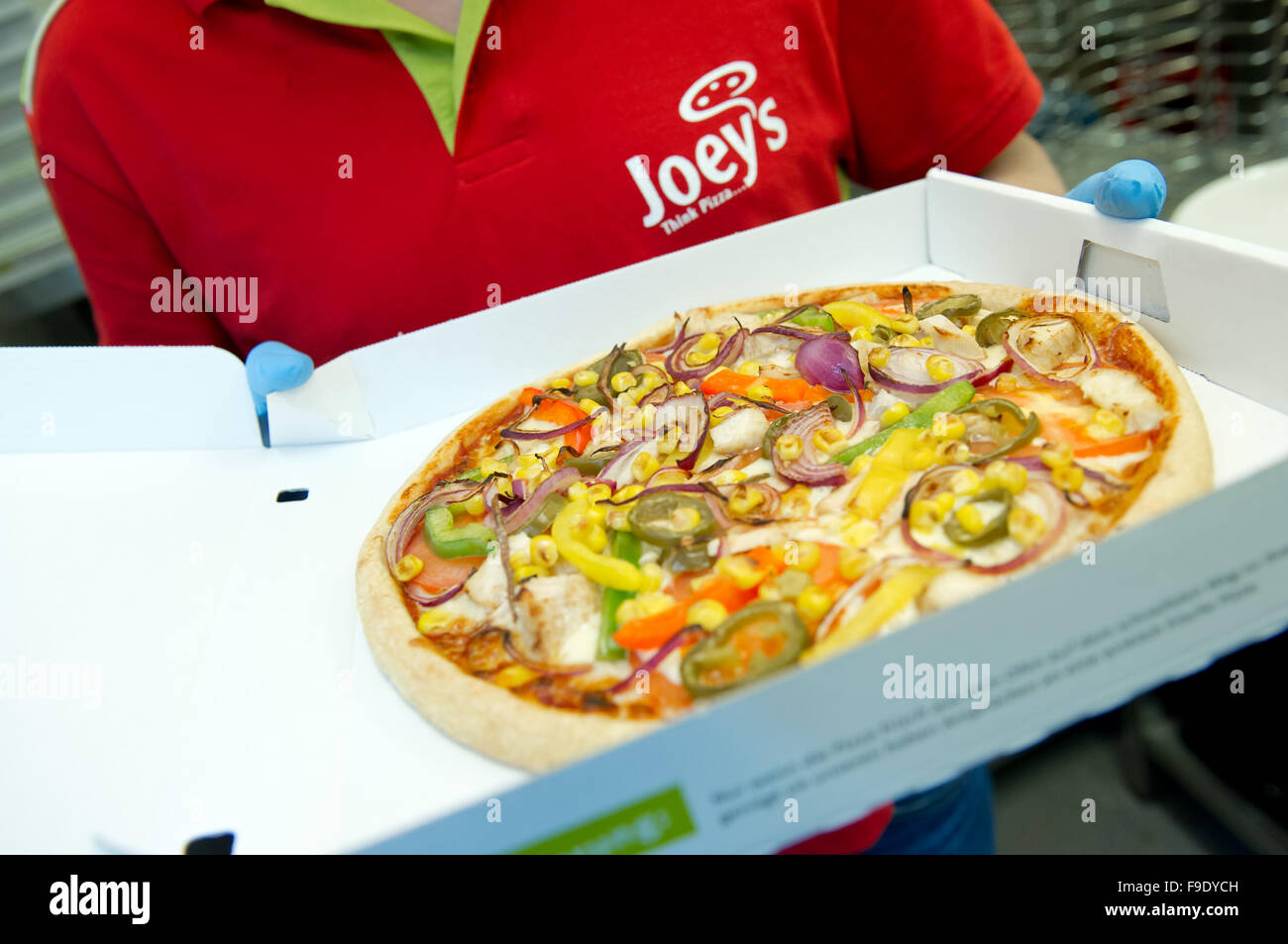 Hamburg, Germany. 24th May, 2013. An employee of Joey's Pizza Delivery holds a box with a pizza in Hamburg, Germany, 24 May 2013. At the moment, the company, which was founded in 1988, has 130 franchise partners throughout Germany. Photo: SVEN HOPPE/dpa/Alamy Live News Stock Photo