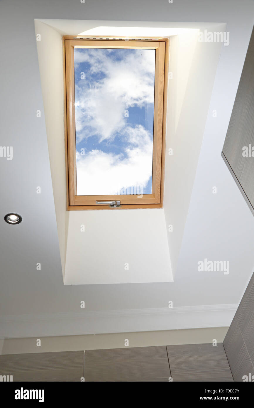 a roof window in a recessed ceiling opening above kitchen units showing