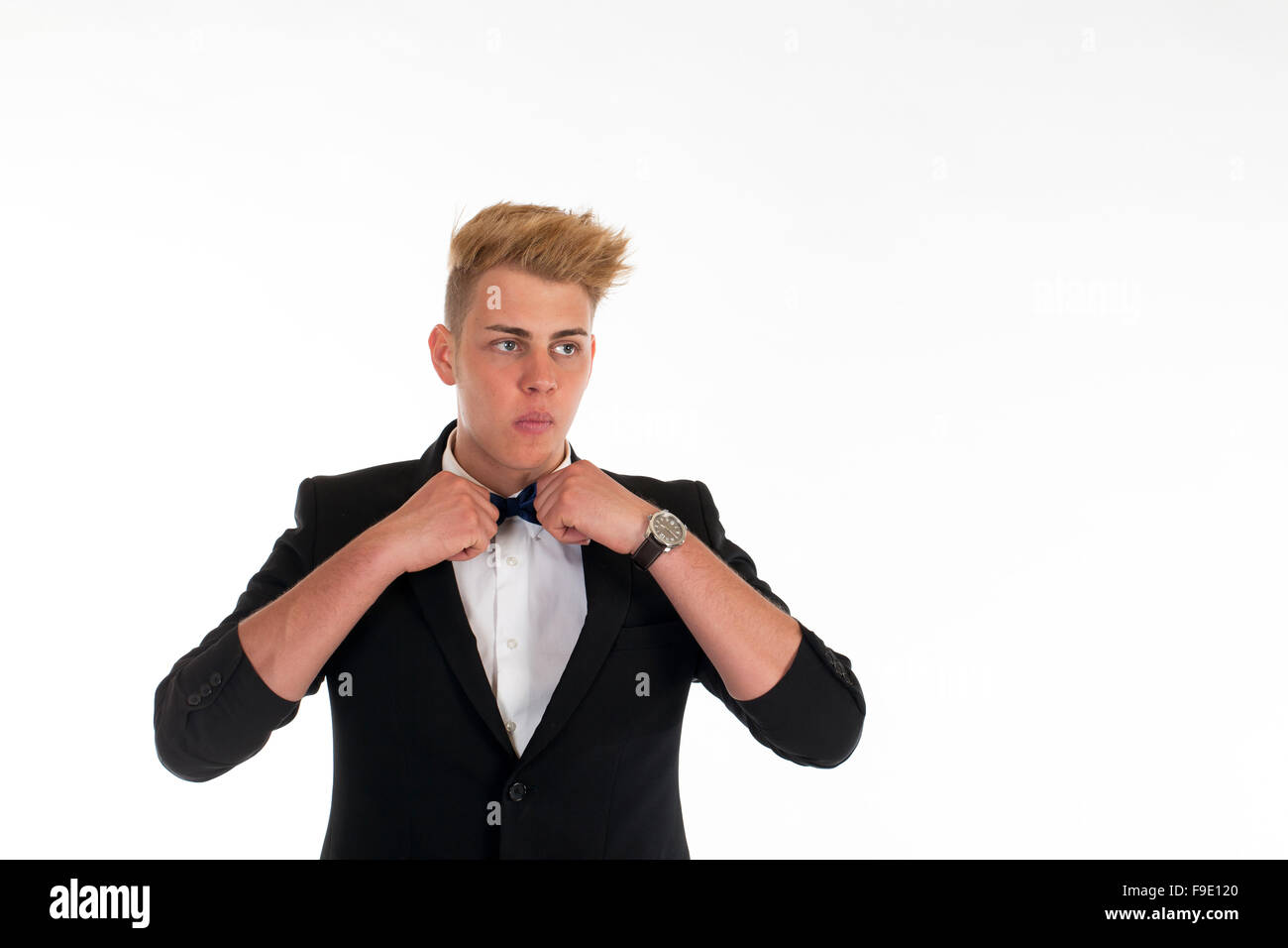 Close-up portrait of a handsome young man in a business suit on white ...