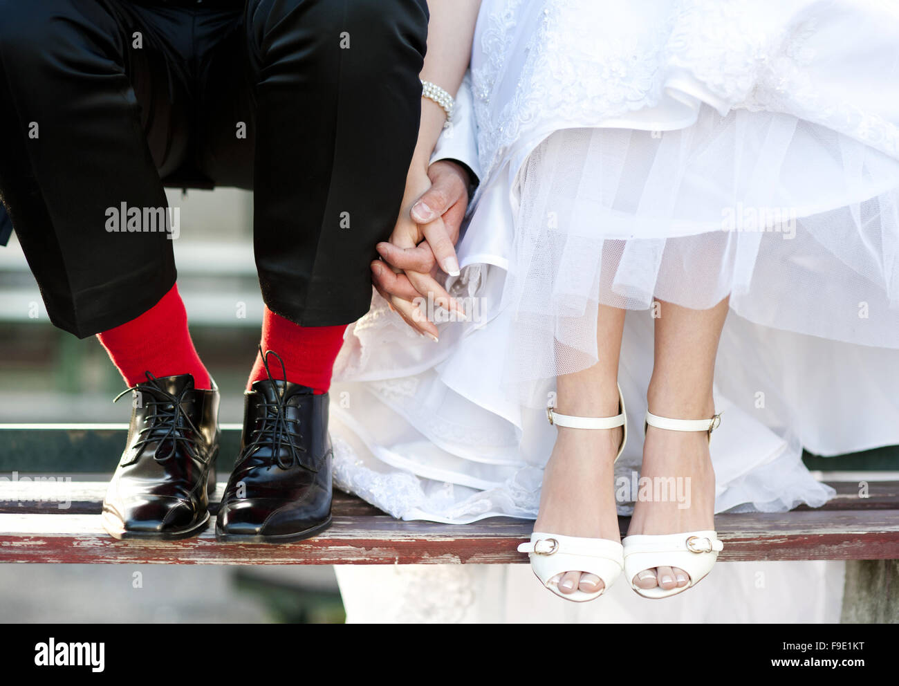 Groom's funny feet with love sign on red socks. Stock Photo