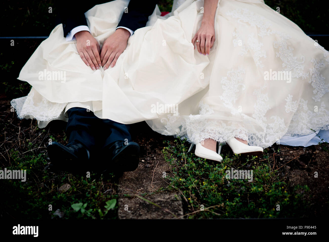 Bride and groom are sitting outside together Stock Photo - Alamy