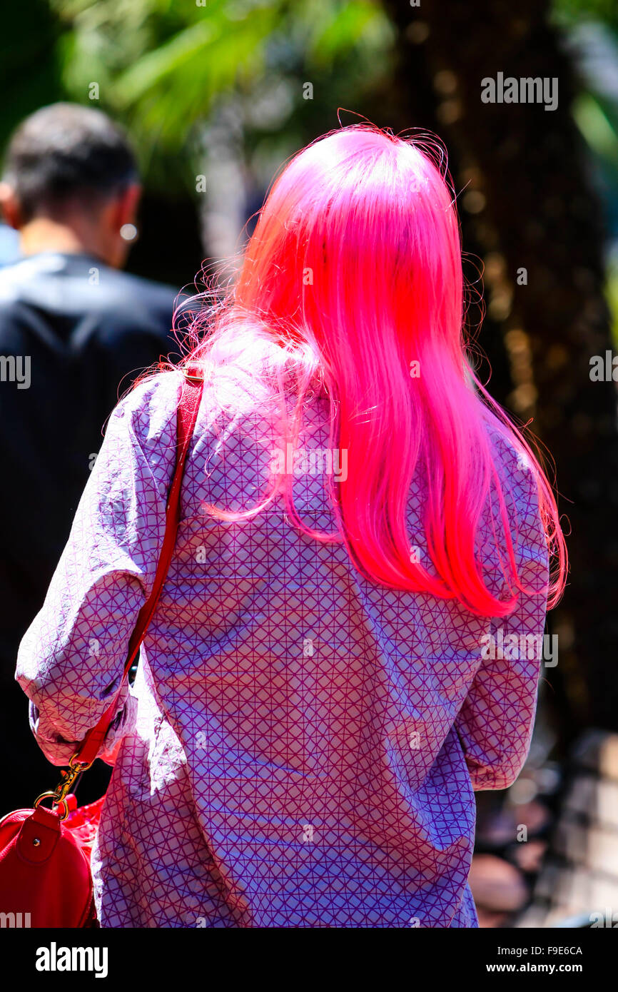 back view of a woman with long pink colored hair in downtown Santa Barbara CA Stock Photo