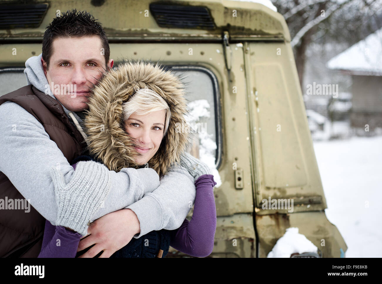 Happy couple is relaxing in snowy countryside Stock Photo - Alamy