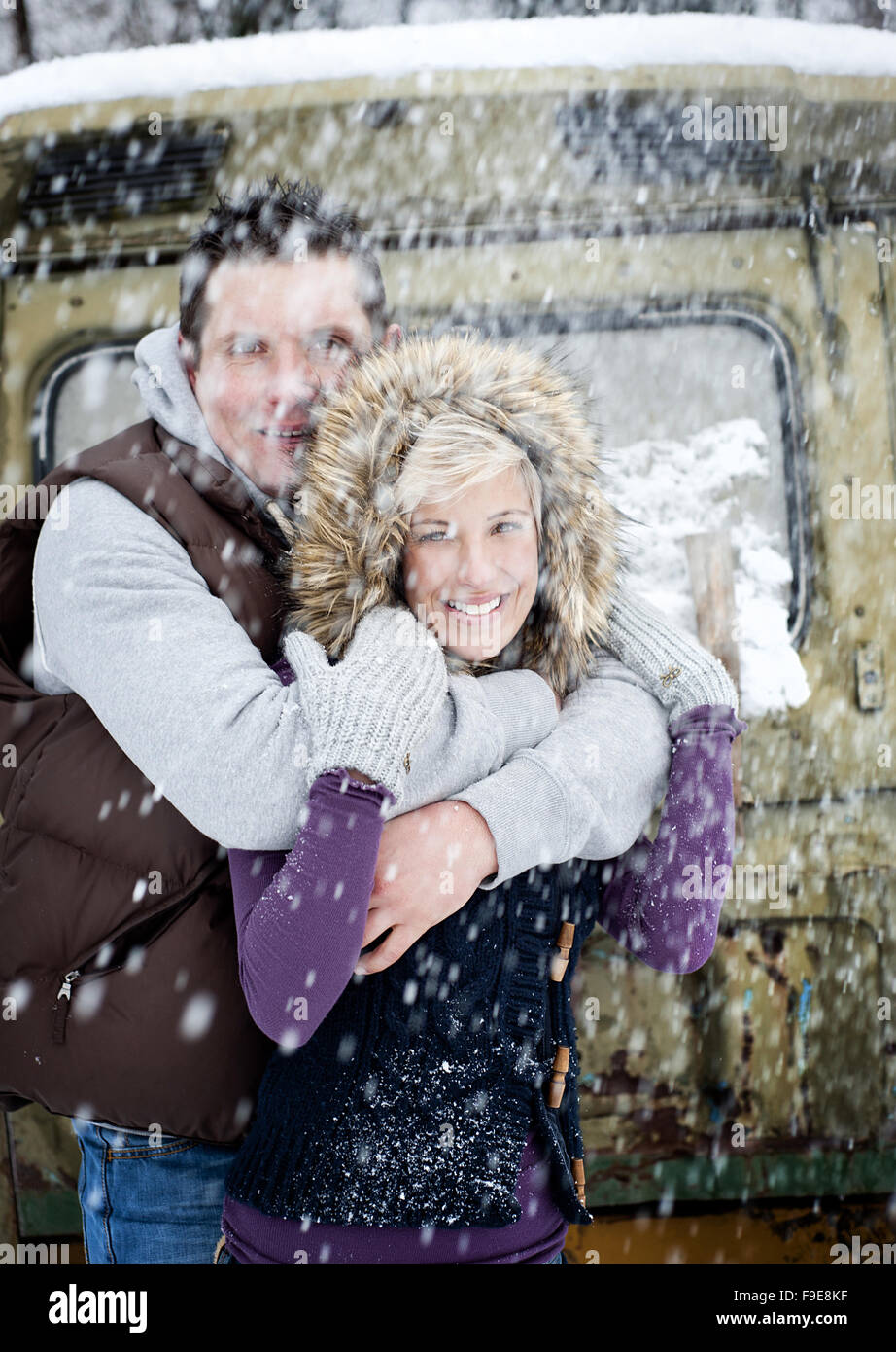 Happy couple is relaxing in snowy countryside Stock Photo - Alamy