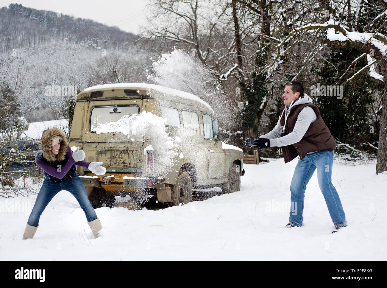 Happy couple is relaxing in snowy countryside Stock Photo - Alamy