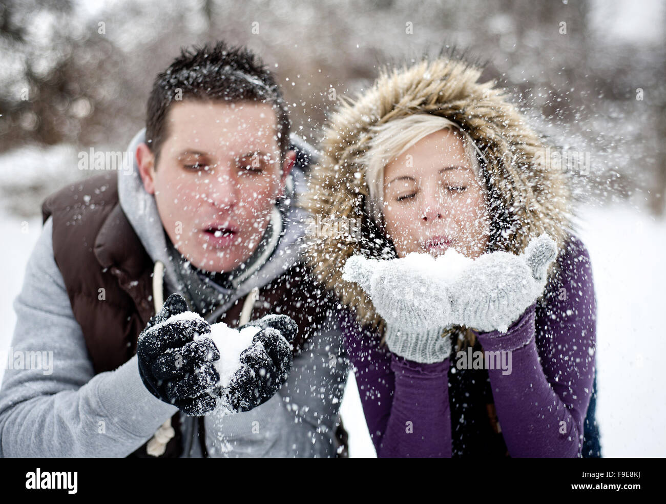 Happy couple is relaxing in snowy countryside Stock Photo - Alamy