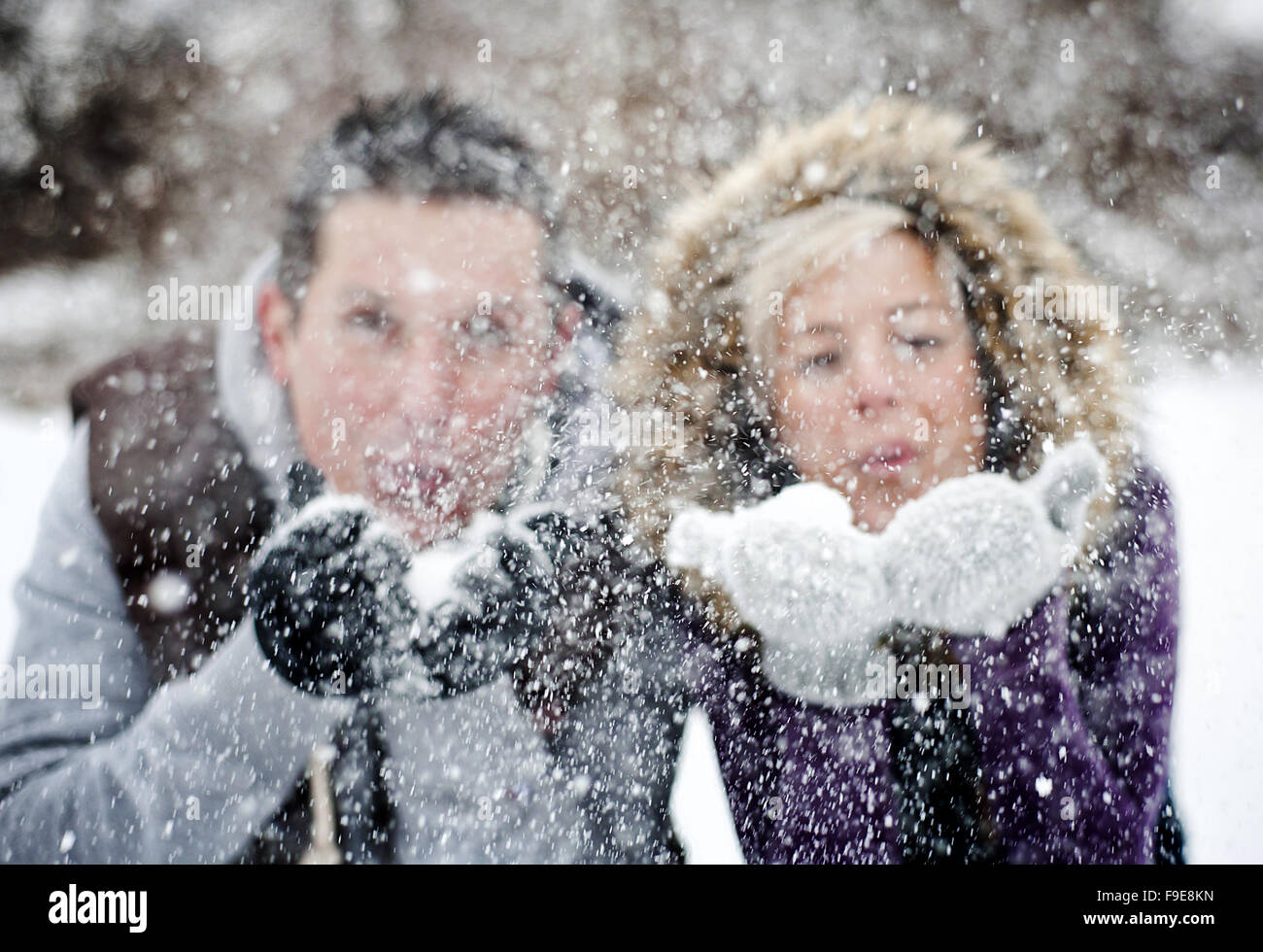 Happy couple is relaxing in snowy countryside Stock Photo - Alamy
