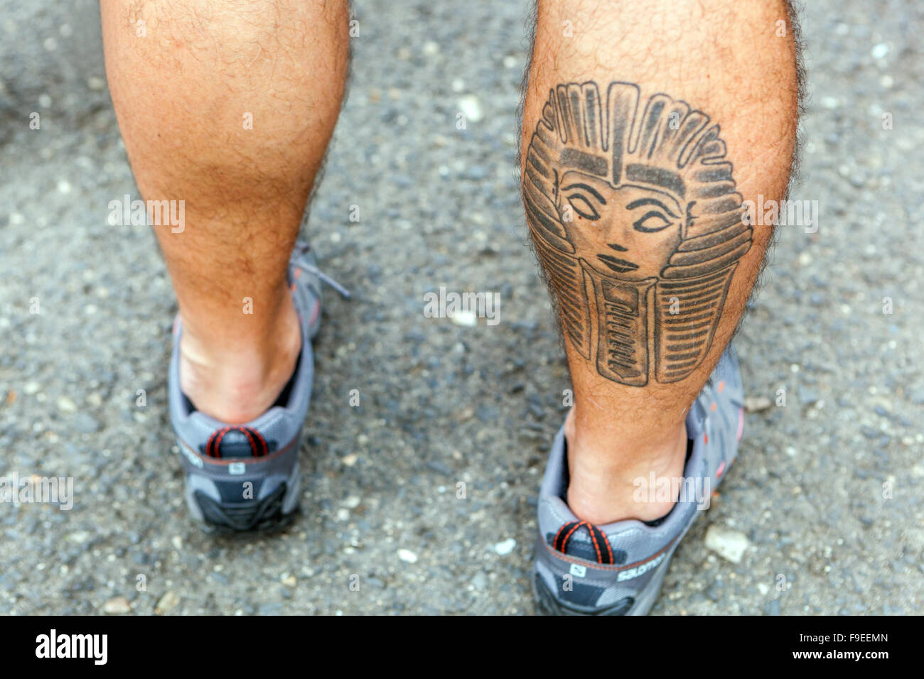 Tattooed male calf muscle Stock Photo