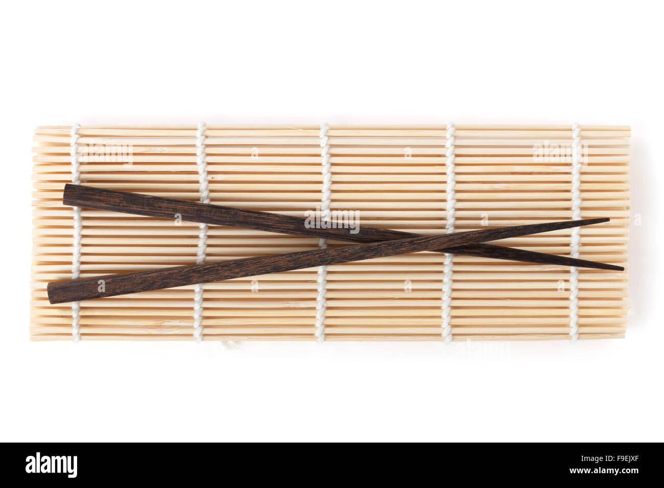 Chopsticks over bamboo mat. Isolated on white background Stock Photo