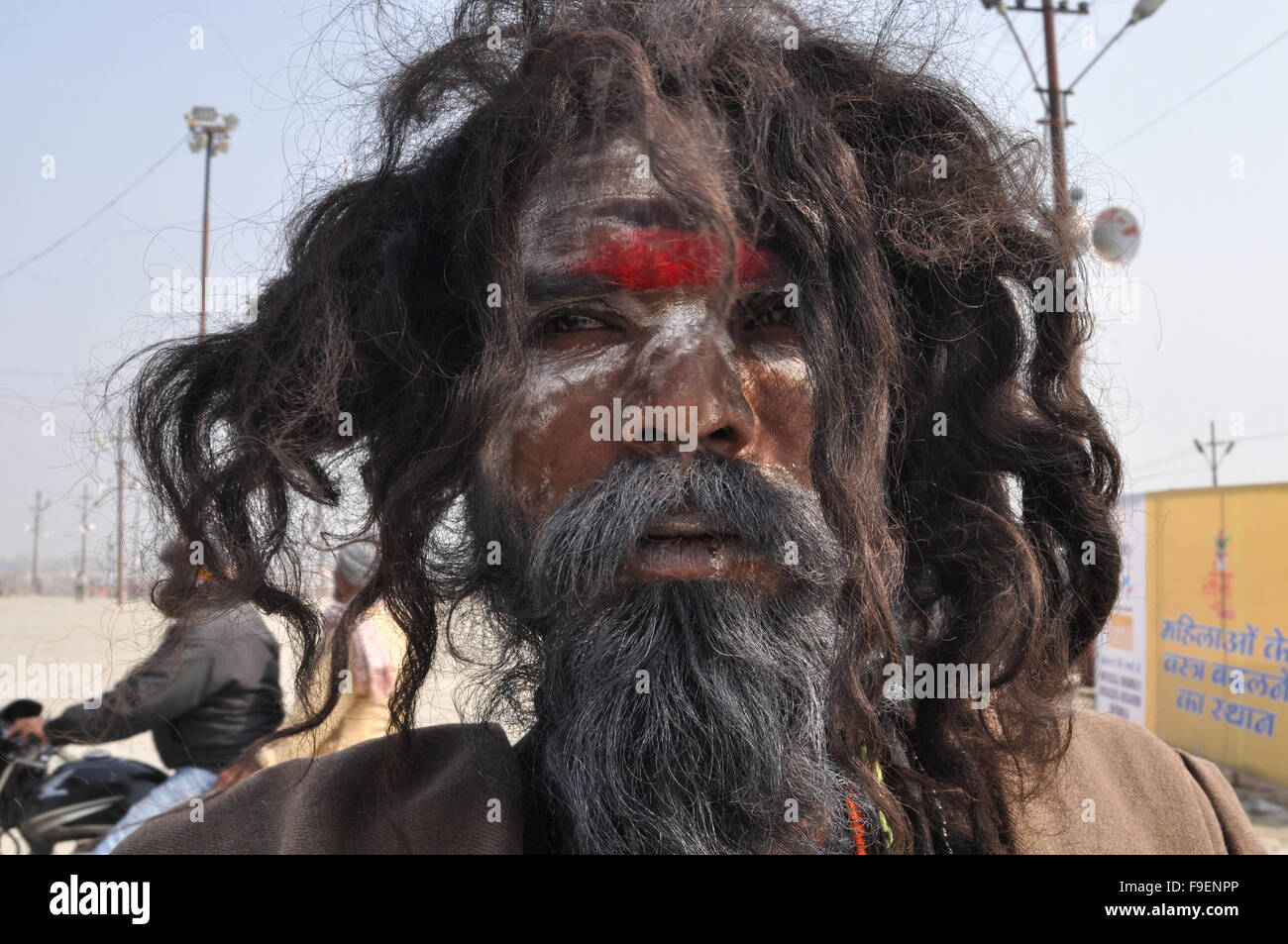 An Aghori Sadhu with long hairs, ash and tilak on face wearing rudraksha bead at Mahakumbh mela, Allahabad, Uttar Pradesh, India Stock Photo