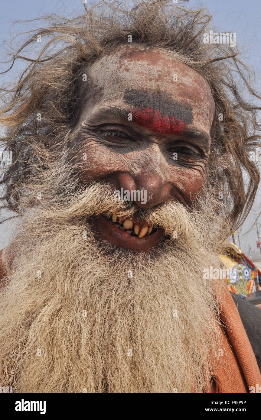 Smiling Aghori Baba with long hair, ash on face wearing human bones,rudraksha bead at Mahakumbh, Allahabad, Uttar Pradesh, India Stock Photo