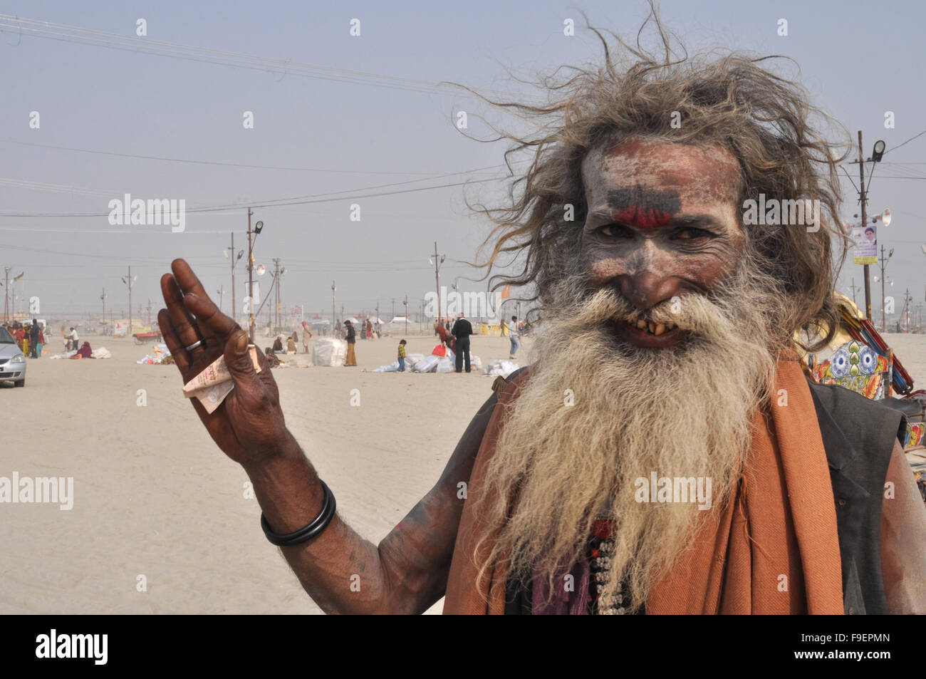 Blessing of an old Aghori Baba, with long hairs, ash on face, wearing rudraksha bead at Prayag, Allahabad, Uttar Pradesh, India. Stock Photo