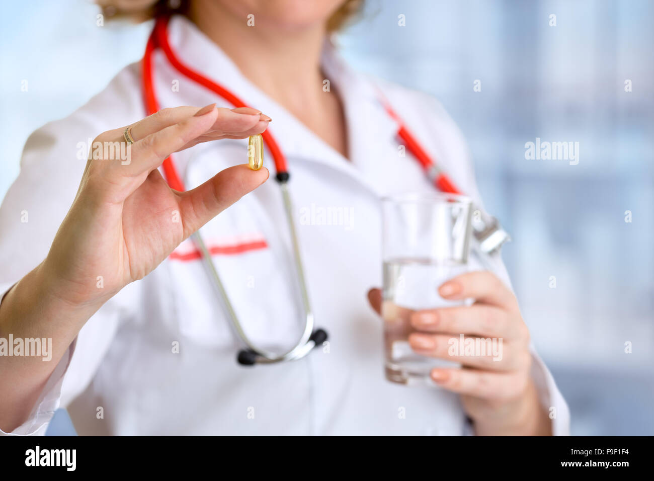 Doctor woman showing pill in hand Stock Photo