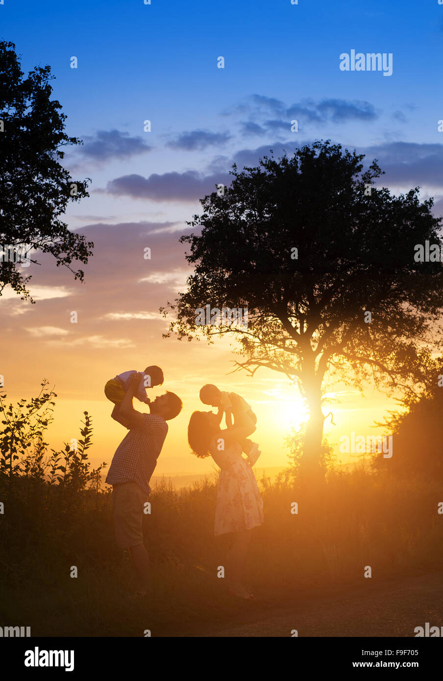 Happy young family spending time together outside in green nature. Stock Photo