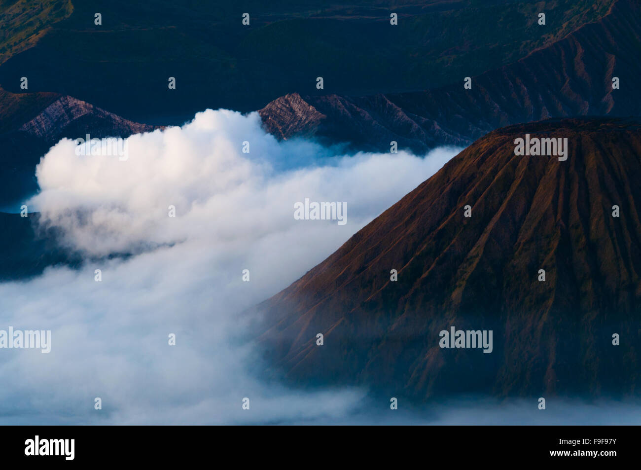 Thick Fog Around the Mountains of Volcano Bromo Stock Photo