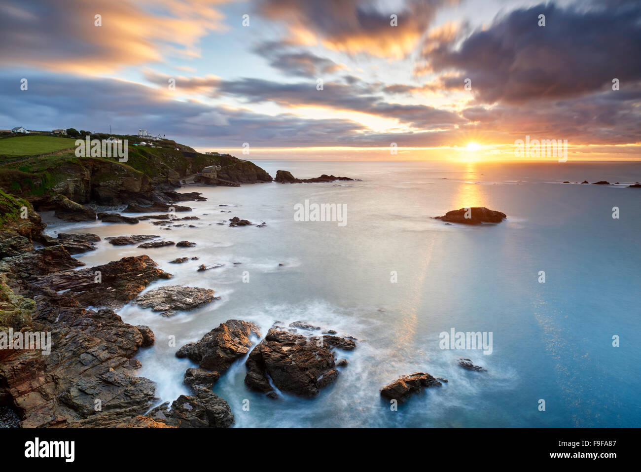 A winter sunrise over Polpeor Cove, The Lizard Cornwall Stock Photo